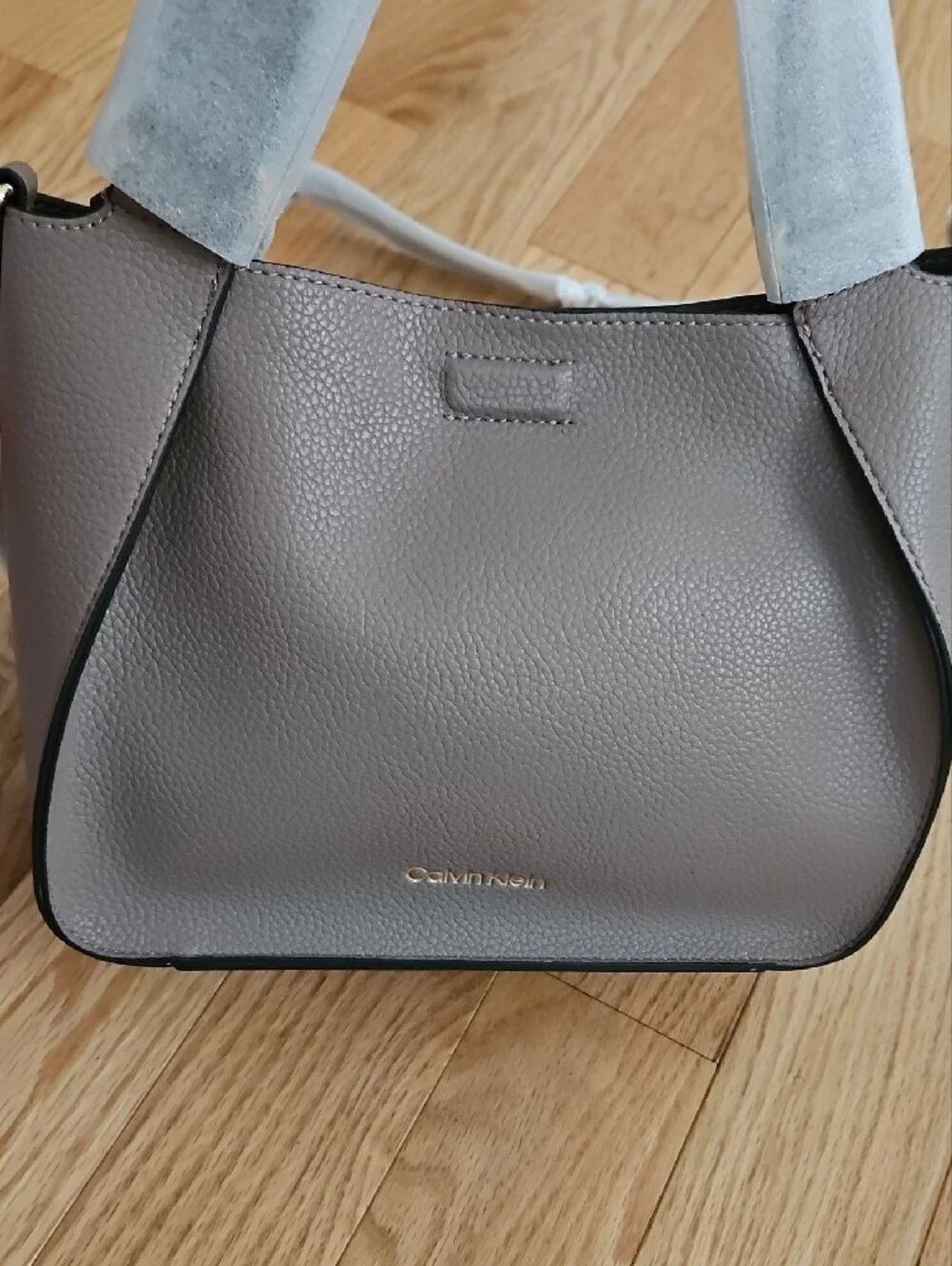 Calvin Klein small neutral tote with gold hardware. Includes a crossbody strap.